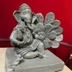 A close-up view that highlights the expression on Bappa's face and the texture of the Shadu clay. This eco-friendly Ganesha statue is made without any paint or chemicals.