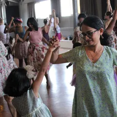 A mother and daughter hold hands and dance during our special Mother's Day class. These events create beautiful, lasting memories for our families.