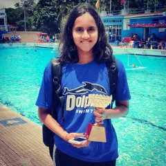 Success looks good on our swimmers. This student's hard work in training is reflected in the trophy she's holding. It's moments like these that fuel my passion for coaching.