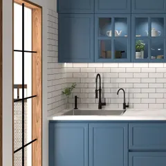 For those who love timeless design, this kitchen features classic shaker-style cabinetry in a deep blue, paired with a clean white subway tile backsplash. The black fixtures and fittings add a touch of modern contrast to this elegant space.
