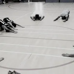 A cool-down session is just as important as the main workout. Here, our players are performing deep stretches in a circle, helping with muscle recovery and promoting mindfulness after an intense training session.