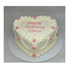 A gorgeous heart-shaped vintage cake with a mixed fruit flavor. The intricate piping and small pink rosettes give it a classic, retro feel, perfect for a special birthday.