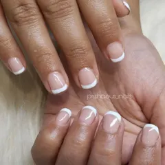 A simple and clean white French manicure on short, natural nails. This is the definition of timeless elegance.