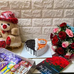 This is what I call a complete birthday surprise package! 🤌🏻 It features a heart-shaped, half-and-half cake, a fresh flower bouquet, a big box of assorted chocolates, and a cuddly teddy bear. I can help you put together a similar personalized hamper for your loved one.