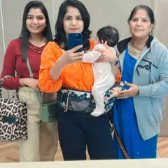 A mirror selfie with my sister, mom, and my little one in a Buttbaby carrier. Three generations of love in one frame.