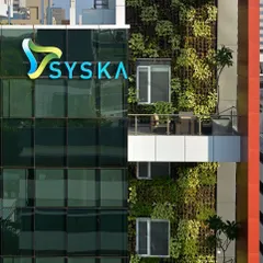 A close-up of the green wall on the Syska building, showing the density and texture of the vertical garden.