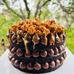 The perfect treat for a rainy day. This is my naked chocolate cake with salted caramel, chocolate ganache dollops, and a topping of crunchy caramel popcorn.