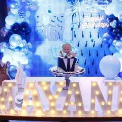 A full view of our Boss Baby birthday setup. This shows the main cake table with light-up marquee letters, a themed backdrop, and coordinated balloon columns, creating a cohesive and impressive look.
