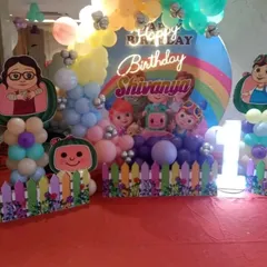 Another Cocomelon theme, this time with a rainbow backdrop and a cute picket fence. The pastel balloon colors make this a very cheerful setup for a little one's birthday.