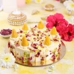 This is my Kesar Peda cake, another one of my Indian fusion creations. The cake is flavoured with saffron and cardamom and decorated with crumbled pedas, pistachios, and rose petals for a truly festive treat.