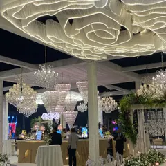 A wide shot showcasing the scale of a custom ceiling installation. The combination of the glowing fabric sculpture and dozens of crystal chandeliers demonstrates my team's ability to execute large-scale, complex production designs.