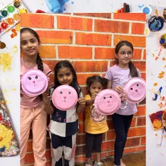 Our art and craft workshops are a place for little artists to shine. Here, a group of proud creators show off their finished paper plate animals, a fun activity that helps develop fine motor skills and sparks imagination.
