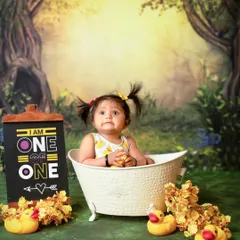 With her cute pigtails and thoughtful gaze, this little one is enjoying her special birthday bath. These sessions are all about capturing your child's personality in a fun setting.