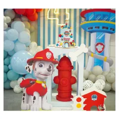 Marshall is all fired up for this Paw Patrol party. The setup includes a life-sized Marshall prop, a fire hydrant, and the iconic Lookout Tower in the background.