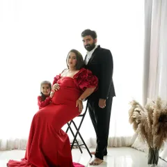 A formal studio portrait celebrating the next chapter. This maternity session captures the elegance and excitement of a growing family, with coordinated outfits creating a classic, polished look.