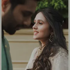 A close-up shot focusing on the bride's radiant smile as she looks at her partner. This frame captures the genuine adoration and happiness in a simple, beautiful way.