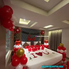 Another view of our romantic room setup, showing the heart-shaped foil balloons and balloon clusters by the window.