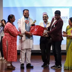 Receiving a token of appreciation at the summit. Events like these are crucial for fostering innovation and collaboration within the Ayurvedic community.