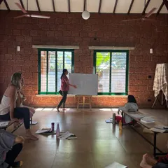 Another student takes the lead at the whiteboard. This practice of teaching helps to connect the dots between different concepts and deepens personal understanding.