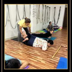 Assisting a student in a gentle backbend to help her recover and realign after an intense practice.
