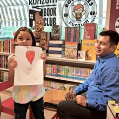 Making memories that last a lifetime. A young artist proudly shows her creation at our art corner, a space always open for doodling and creativity.