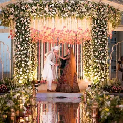 A monsoon wedding that feels like a movie. The mirrored aisle reflecting the stunning floral mandap inside the clear-top tent was a detail that made the backup plan feel like the main event.