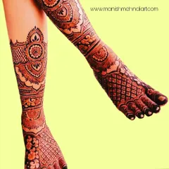 Bridal mehndi isn't just for the hands. We create stunning, full-leg designs that complement your entire bridal look. This intricate pattern covers the legs with beautiful traditional motifs, ensuring you look perfect from head to toe.