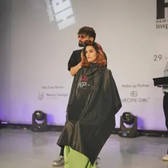 A behind the scenes moment from the Wella live hair show. This shows the makeup application in progress, creating a beautiful base that will complement the final hair styling on stage.