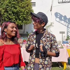 The community vibe at art markets is unbeatable. Here I am sharing a laugh with a friend in front of my stall. These events are all about connection, creativity, and supporting local and queer artists.