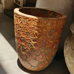 For a more rustic and earthy look, we offer textured planters like this one. The unique, weathered finish adds character and makes a beautiful statement piece for a patio, balcony, or entryway.
