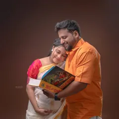We can incorporate meaningful cultural elements into your maternity session. Here, this couple shares a quiet moment with a traditional Marathi book, blending their heritage with the excitement of their new beginning.