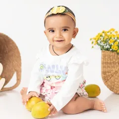 A close up of the birthday girl with her mangoes. Her happy expression shows just how much she enjoyed this personalized and fun photoshoot theme.