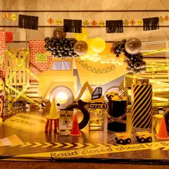 For the little builder in your life, I design action-packed construction zones. This setup features a full-scale backdrop with a dump truck, caution tape, traffic cones, and custom signage, turning the party space into a fun and interactive work site.