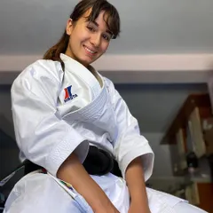 A black belt practitioner smiles with the quiet confidence that comes from years of training. Martial arts is not just about fighting; it's about the inner peace and self-assurance you gain along the way.