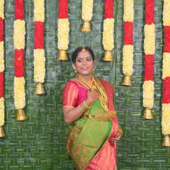 The mom-to-be posing in front of the traditional coconut leaf backdrop. This setup is perfect for capturing the essence of a South Indian baby shower.