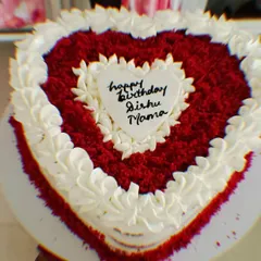 A heart-shaped red velvet cake for a birthday celebration. Layered with my signature cream cheese frosting, this cake is as rich in flavor as it is in love.
