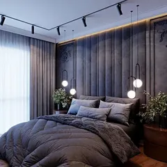 We created a moody and dramatic ambiance in this bedroom with a dark, vertically padded accent wall and track lighting. The simple bedding and sheer curtains balance the bold design.