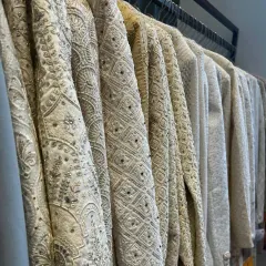 The beauty of a classic ivory sherwani. This rack shows the variety of intricate, tone-on-tone embroidery and sequin work I offer in my men's collection.