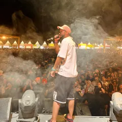 Mic in hand, smoke in the air, and a massive crowd in front of me at the Horn OK Please festival. This is the raw energy I bring to every public event and live show.