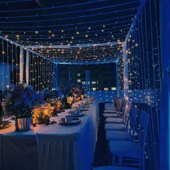 We can transform any space into an elegant setting, like this intimate rooftop dinner. A canopy of fairy lights and deep blue ambient lighting created a magical atmosphere for a special corporate gathering.