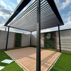 Here is the clean, structural base for a terrace transformation. We've installed a modern black pergola over a composite wood deck, with artificial turf and accent green wall panels ready for furniture and final touches.