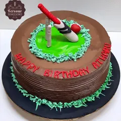 A simple yet effective cricket theme cake. This chocolate truffle cake is frosted with chocolate and decorated with a fondant bat, ball, and wickets on a patch of green.