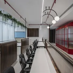 A symphony of cobalt whispers and crimson dreams. This office features a conference room that echoes the charm of a red telephone booth, creating a sanctuary where creativity dials up its brightest colors and every moment sparks with possibility.