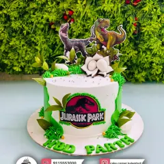 Roar! A Jurassic Park themed cake for Parth's birthday. Featuring a T-Rex and Velociraptor, it's a thrilling cake for any dinosaur fan.