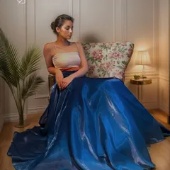 Step into the enchanting twilight with this ethereal evening cocktail dress. Fashioned from delicate glass organza and satin, its flowing silhouette moves gracefully, a perfect symphony for your magical moments.