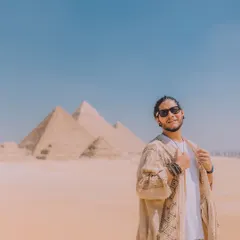 A happy moment in front of the Great Pyramids. This travel portrait is bright and aspirational, perfect for content that inspires wanderlust and adventure.