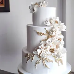 For me, a wedding cake should be pure elegance. This three-tiered beauty features a cascade of handcrafted white and gold sugar flowers, creating a timeless and sophisticated centerpiece. It’s a testament to how classic design can make the most powerful statement on your special day.