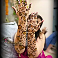The full view of the contemporary floral vine design. Both arms are adorned with this light and airy pattern, showing that mehndi can be both modern and stunning.