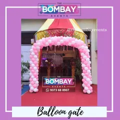 A simple and elegant balloon gate in pink and white, perfect for welcoming guests to a first birthday party or any special celebration.