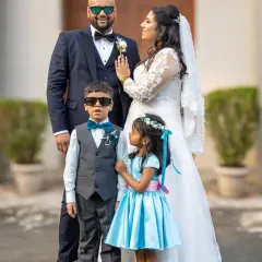 A fun and stylish family portrait. The bride and groom with the page boy and flower girl, who are rocking their own mini sunglasses.